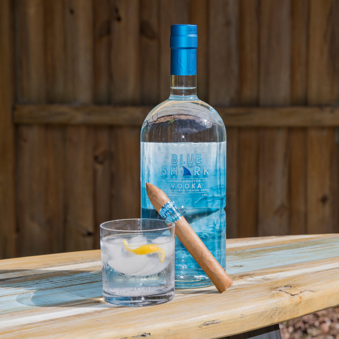 vodka cocktail adjoined with a rolled cigar